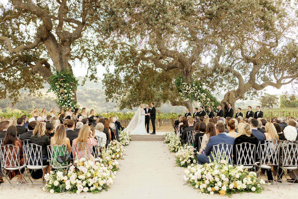 Wedding ceremony beneath the oaks at a Santa Barbara vineyard